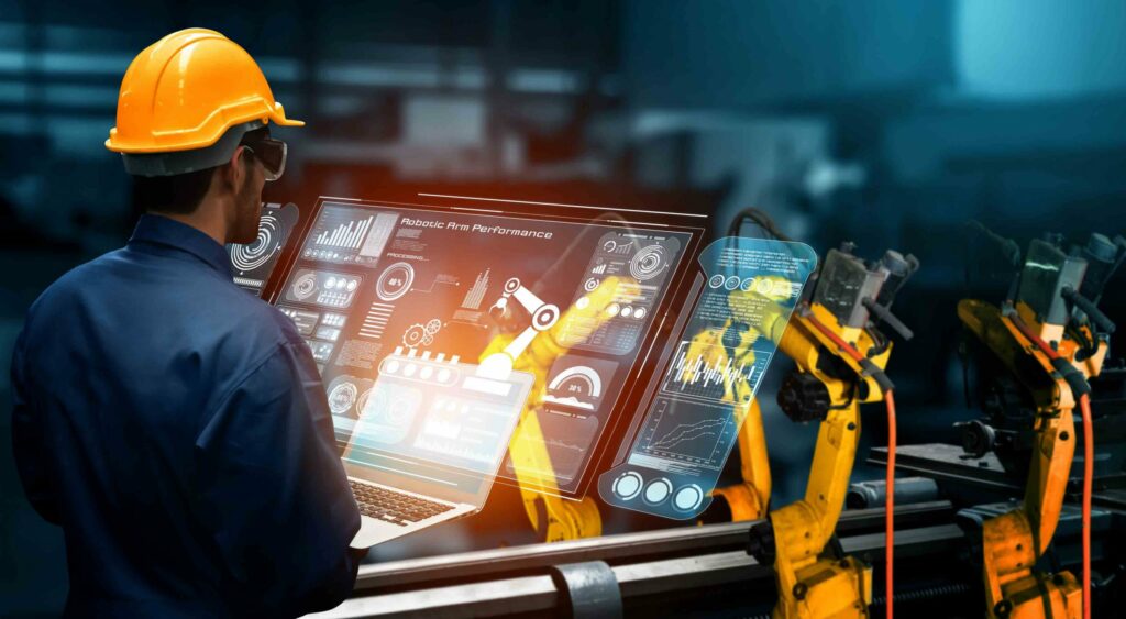 Ingeniør i produktion overvåger robotarme via digitalt dashboard – smart factory og industriel automatisering med AI.